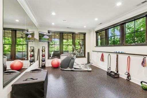 Soundproof gym with rubber flooring and mirrored wall is also a legal 5th bedroom.