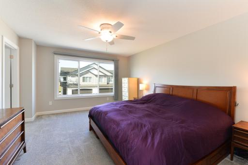 The main bedroom is one of four located on the upper level, offering a comfortable and private retreat.