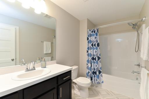 The upper-level bathroom is a full bath featuring a convenient shower and tub combo.