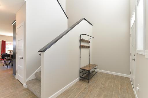 The bright and open foyer area features stairs leading to the upper level, creating a welcoming first impression.