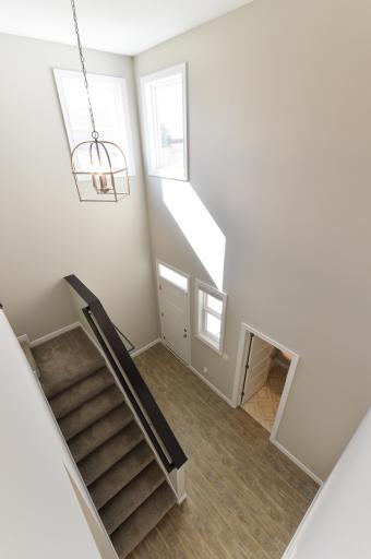 From the loft, you have a clear view of the open foyer, where large windows allow natural light to pour in.