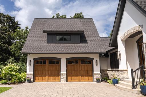Two stall heated garage equipped with vaulted ceilings, EV charger, and a dog wash station