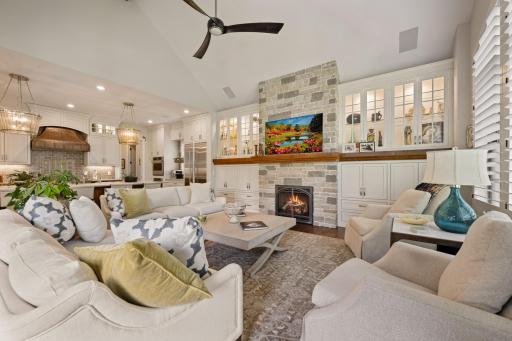 Informal living room off the kitchen with a stone gas fireplace and vaulted ceilings