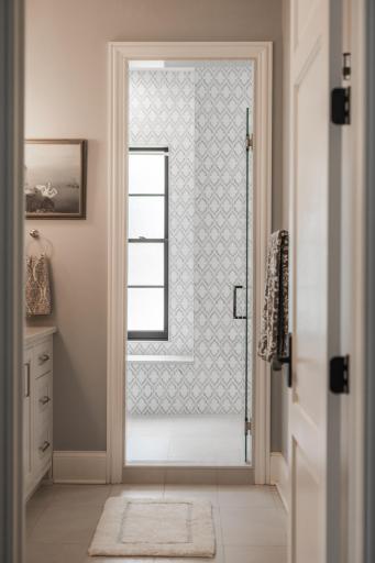 Glass door leading to the expansive wet room