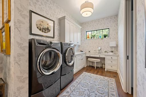 Primary suite laundry and dedicated vanity space
