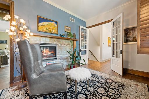 The office features a beautiful marble gas fireplace