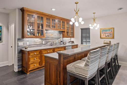 Down to the high ceiling basement you will be greeted by this gorgeous custom built bar