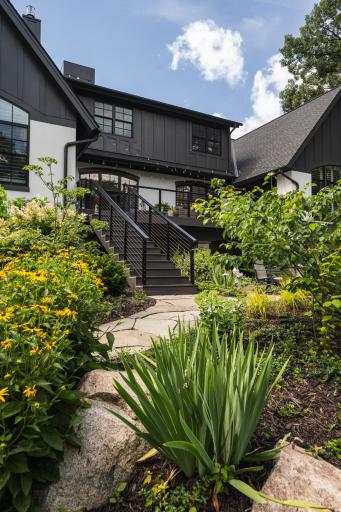 Custom gardens, landscaping, and water feature are just a few perks of this backyard