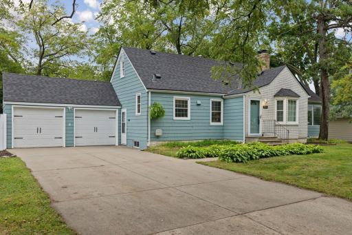 Extra large concrete driveway with double garage stalls and new garage doors.