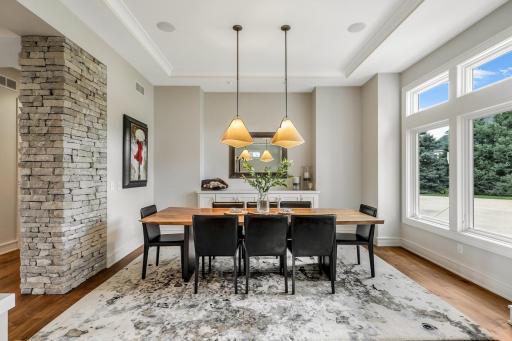 Spacious formal dining room with tray vaulted ceilings and built-in hutch with rollout shelves
