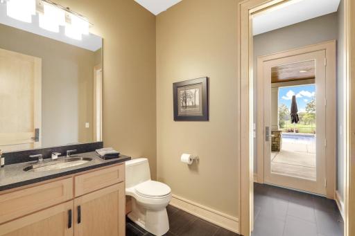 Lower level guest bath with changing room that leads out to the pool