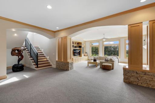 The walkout lower level features an expansive game room, family room, bar area in addition to 3 spacious bedrooms