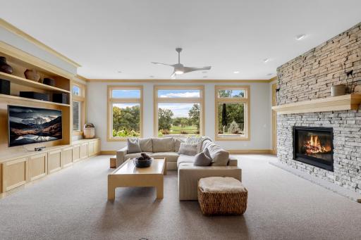 Gas fireplace in lower level with stone surround