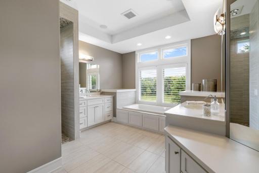 Spa-like primary bathroom with dual vanities