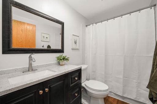 Stylish and updated bathroom on the upper level, adjacent to three bedrooms