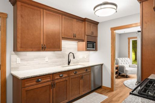 Newly renovated kitchen featuring granite countertops and custom cabinetry