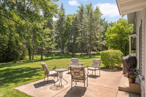 Spacious backyard retreat featuring a newly poured concrete patio for outdoor enjoyment