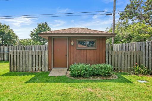 Storage shed with all of the pool supplies on a concrete pad