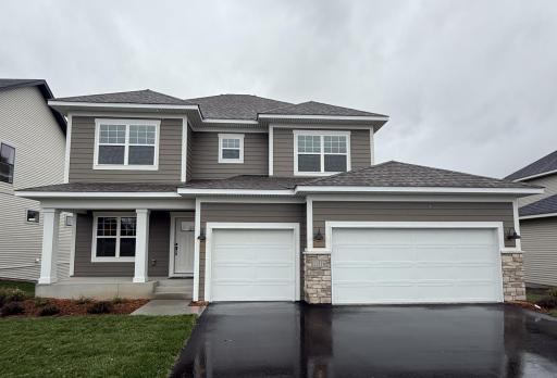 Charming two-story with 3-stall garage and inviting front porch!