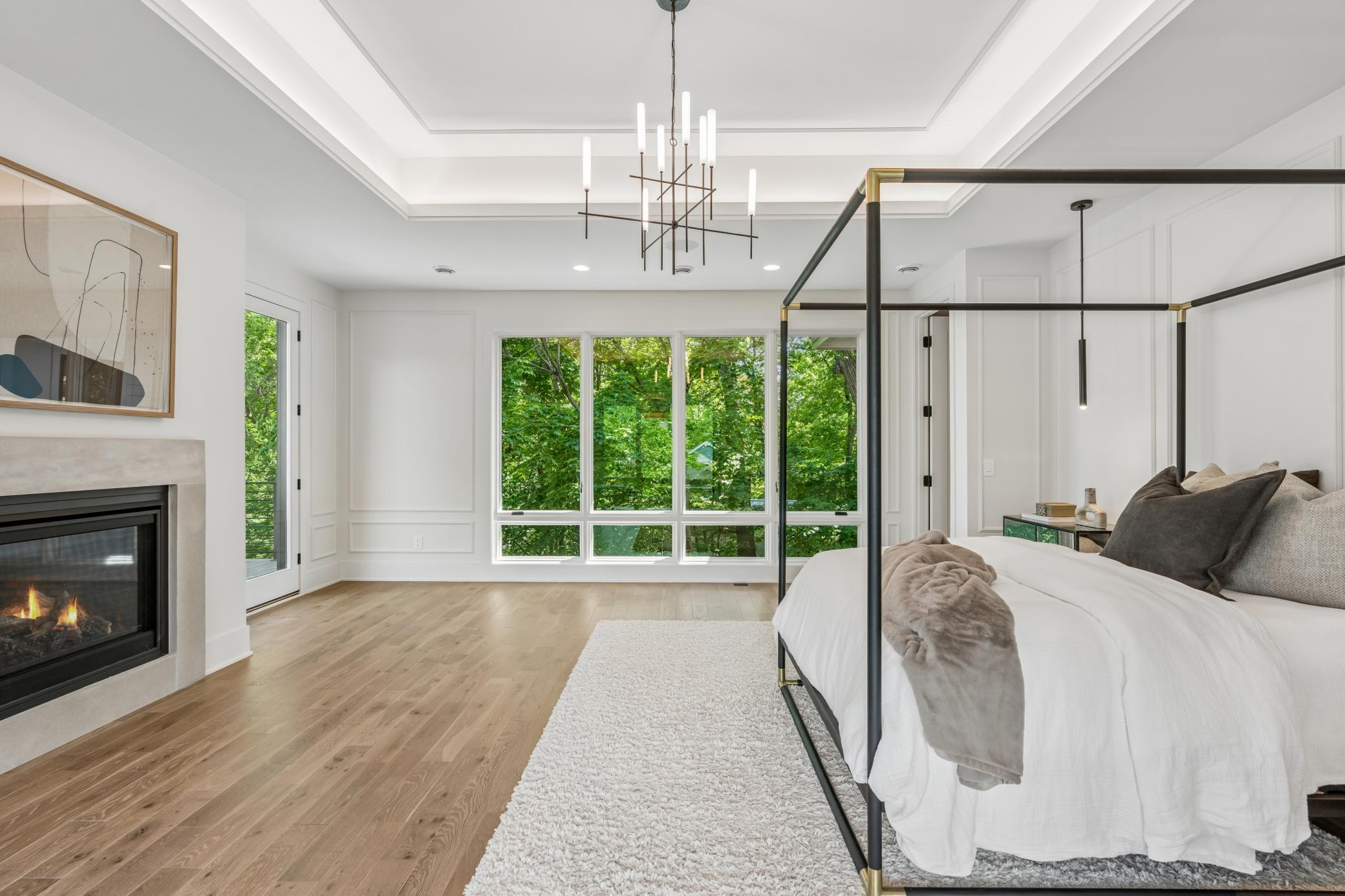 Incredible master suite with lounge area, limestone fireplace, excellent ceiling lighting details, private deck, large bathroom and walk in closet