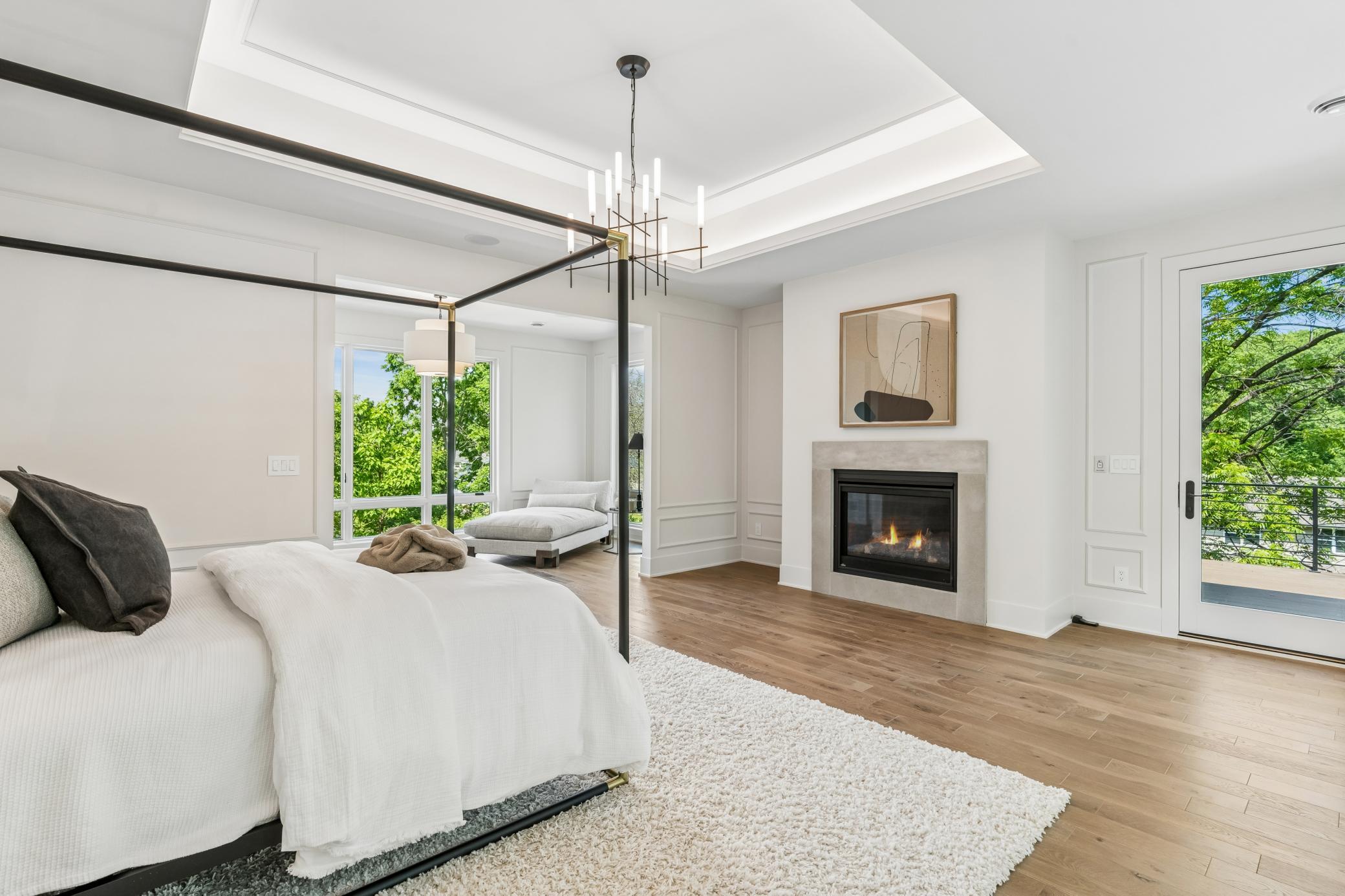 Incredible master suite with lounge area, limestone fireplace, excellent ceiling lighting details, private deck, large bathroom and walk in closet