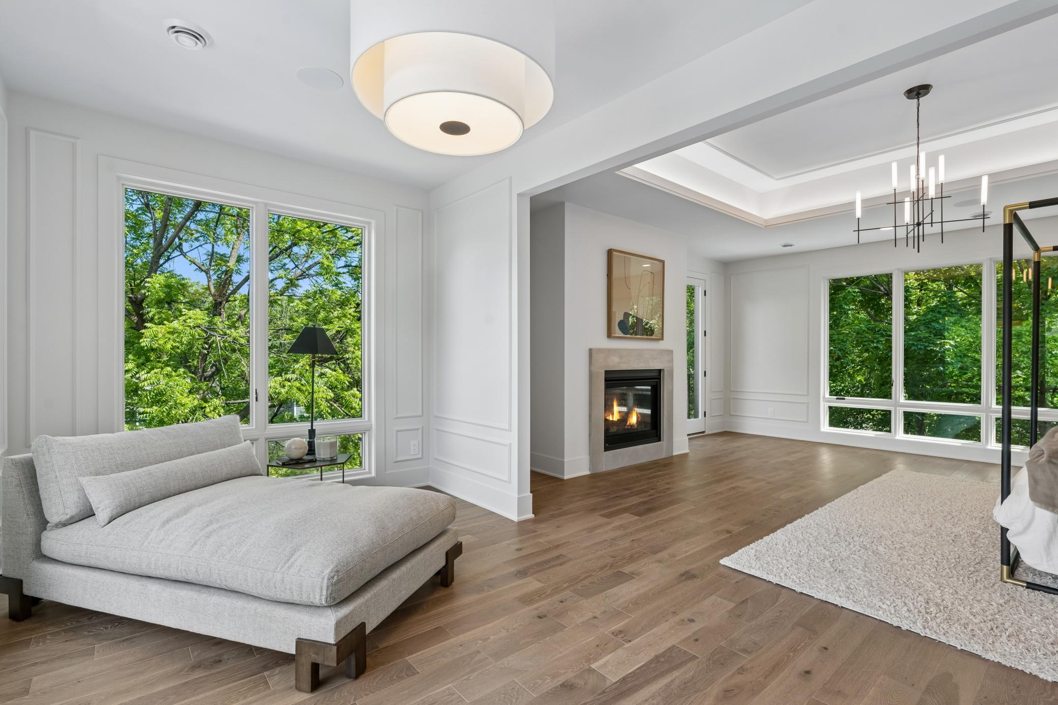 Incredible master suite with lounge area, limestone fireplace, excellent ceiling lighting details, private deck, large bathroom and walk in closet