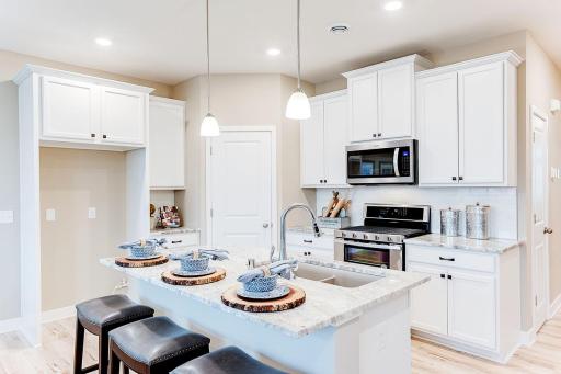 A cozy kitchen with an oversized walk in pantry! MODEL HOME PHOTOS, COLORS AND SELECTIONS WILL VARY!