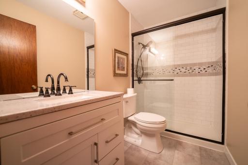 Completely remodeled bathroom on the main level including new vanity, countertop, sink, toilet, flooring and beautiful step in shower with real tile. This was professionally done!