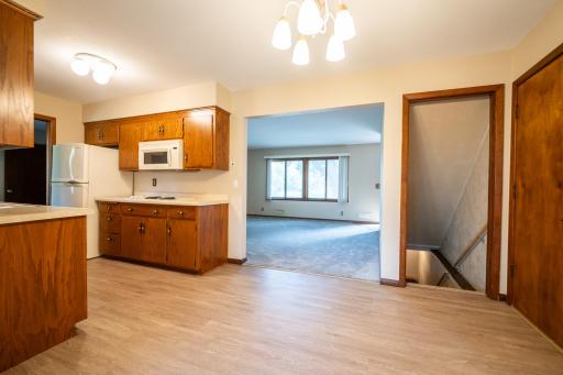 In this photo you can see not only the informal dining area of the kitchen you can see the pass through into the living room. Notice the newer flooring and fresh paint.