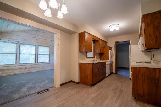The living room as well as this beautiful four-season porch with vaulted ceiling is open to the kitchen. Making this home a great place to entertain.