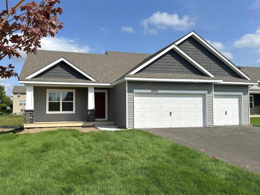 12305 71st Ct NE features the desirable Northern Craftsman elevation with added stone accents. West facing front porch makes for the perfect place to watch the picturesque Otsego sunsets. Picture is of the actual home.