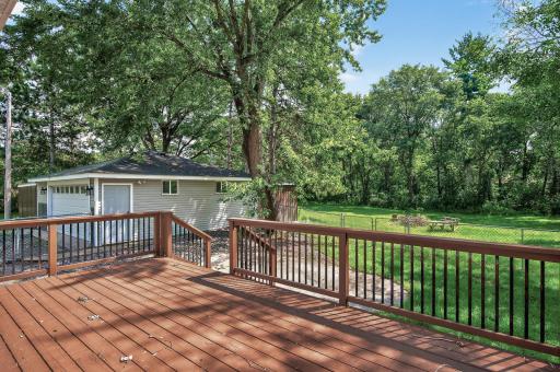 Deck that Overlooks the Acreage Lot and Patio