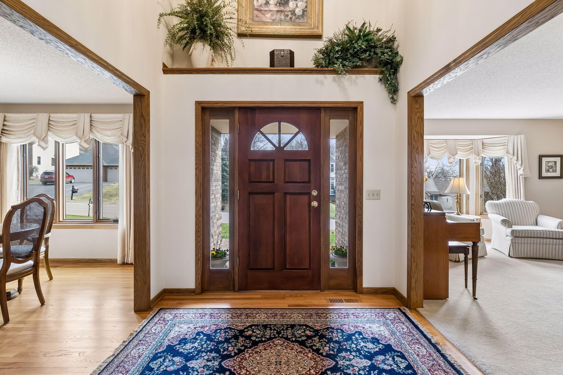 Dramatic 17.5-ft vaulted entry with hardwood flooring
