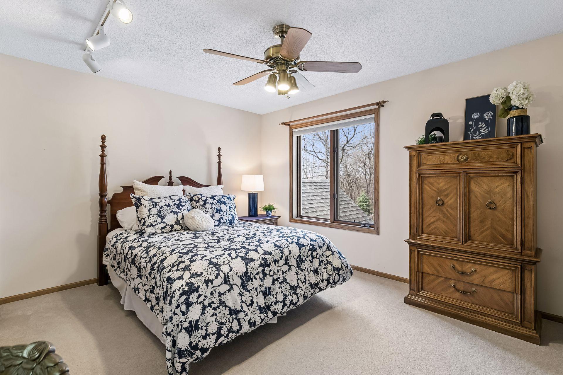Third upper level bedroom with ceiling fan.