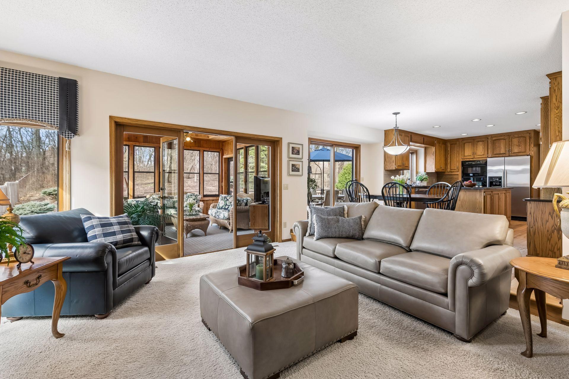 Opening effortlessly to the kitchen, informal dining area, and a beautifully finished three-season sunroom wrapped in cedar and windows.
