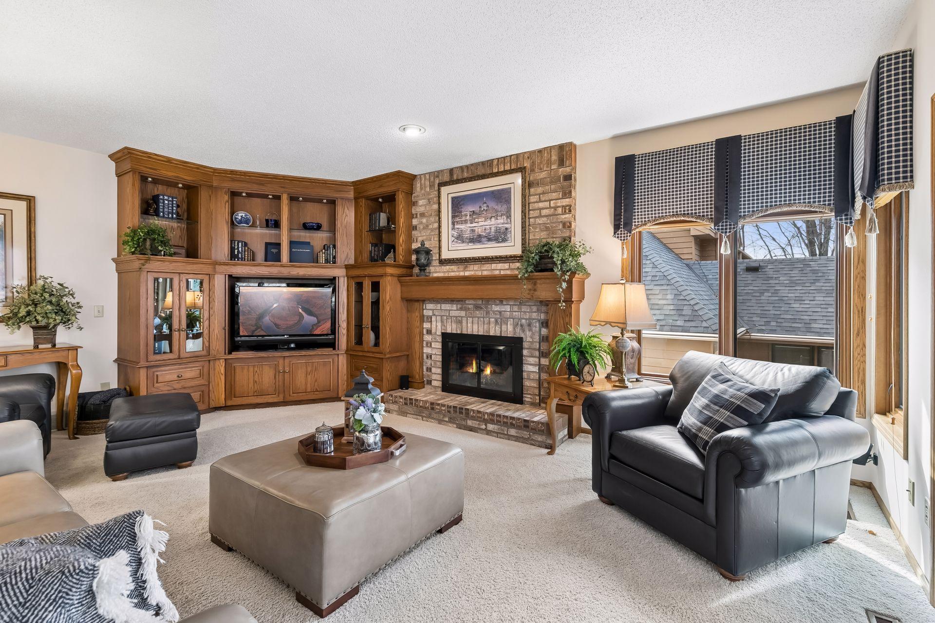 Inviting family room with wood-burning fireplace & custom built-ins.