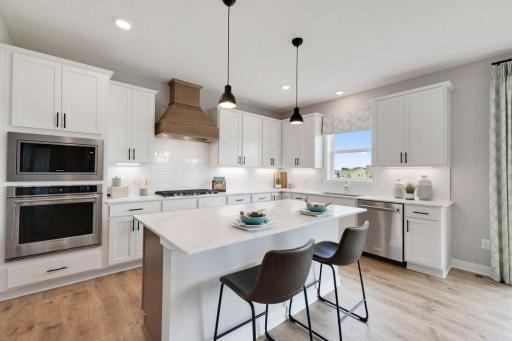 Welcome to this showcase kitchen! Two tone cabinets along with decorative hood vent and accent undercabinet lighting make for an undeniable WOW factor.