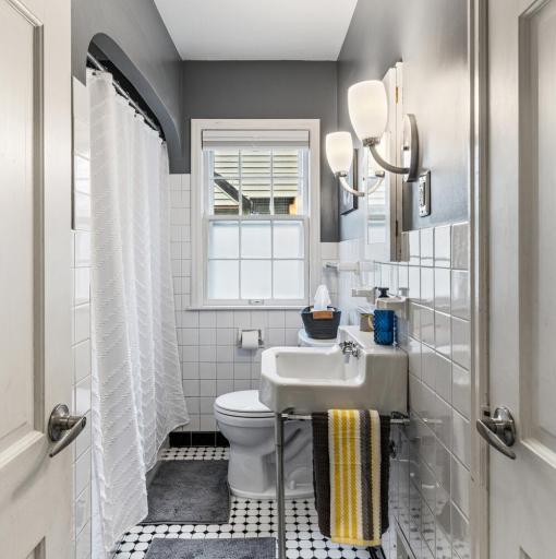 The beautiful main level bathroom maintains original charm.