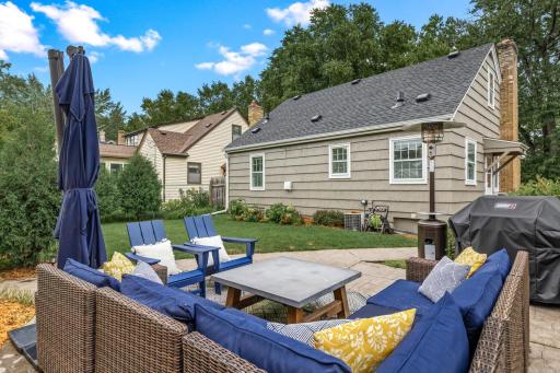 Outdoor living and lush green grass are abundant.