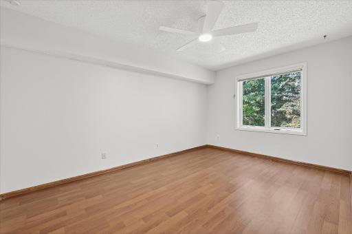 The second bedroom on the upper level. Most ceiling fans have been updated in the home.