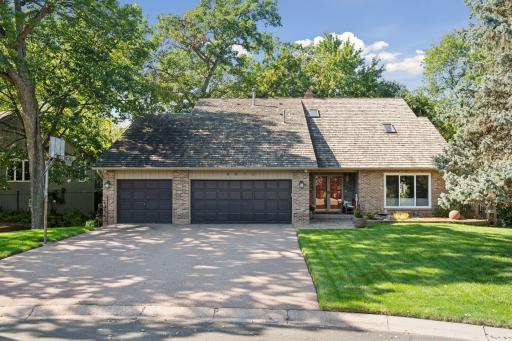 Welcome home to this charming brick home, featuring a beautifully landscaped front yard and an inviting paver stone walkway.