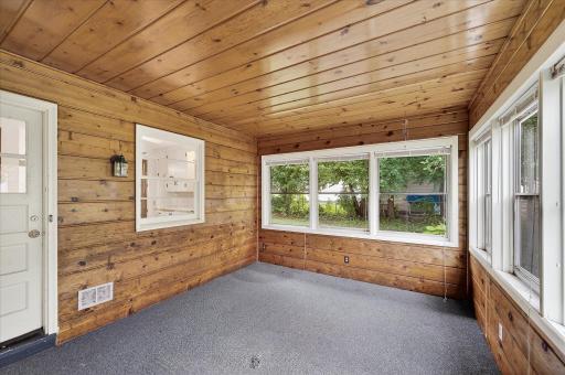 Spacious 3 season porch with access to garage and backyard