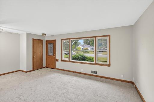Main floor living room with new carpet and fresh paint