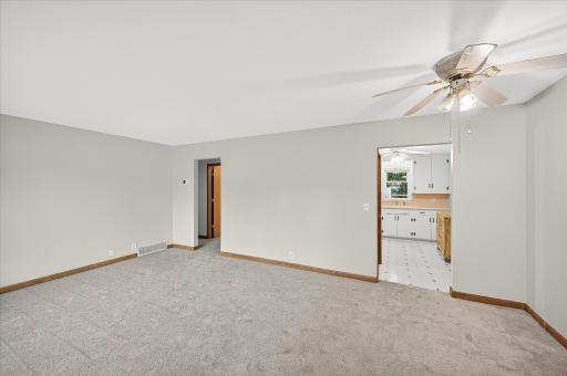Main floor living room with new carpet and fresh paint