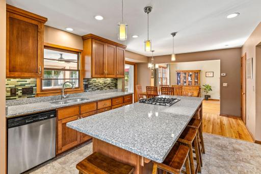 Spacious, updated kitchen flows beautifully into dining area and four season sunroom.