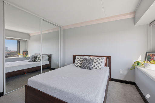 Wall of closets provide plenty of storage in the bedroom