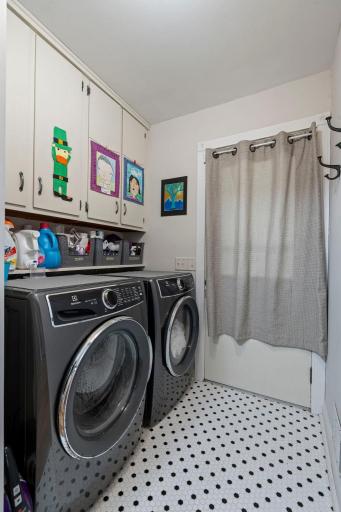 Main floor laundry with door to back deck, tiled floor