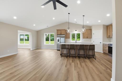 Bright, open-concept layout seamlessly connects the kitchen, dining area, living room, and sunroom, creating the perfect space for everyday living and entertaining.