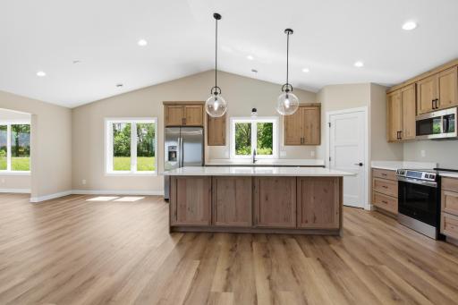 A beautifully designed kitchen overlooks the dining and living spaces, allowing you to stay connected with family and guests.