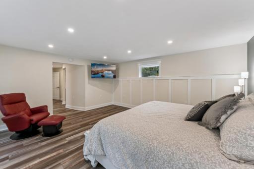Primary bedroom has wainscot wall treatment